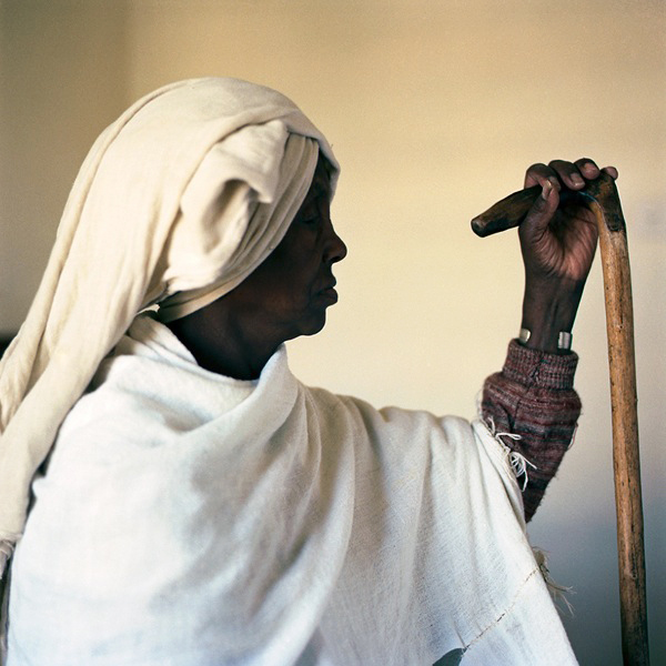Ethiopian Woman in profile holding cane