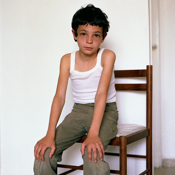 Young Boy sitting on chair